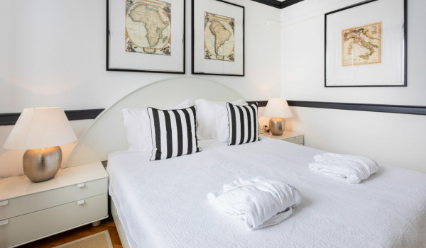 King size bed with striped pillows in the modern beachfront villa Sea Diamant in Dubrovnik
