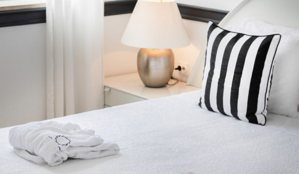 King size bed with striped pillows in the modern beachfront villa Sea Diamant in Dubrovnik