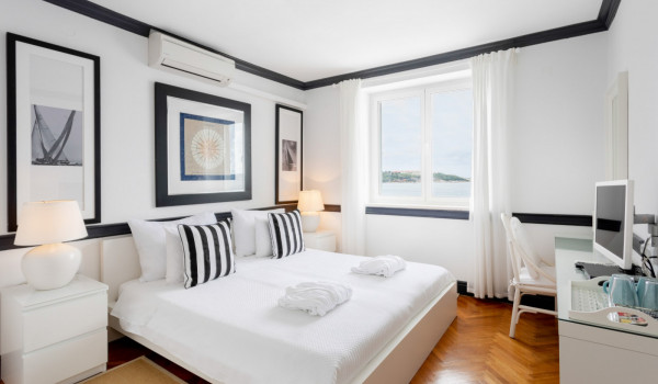 Bedroom with king size bed and working station in the luxury beachfront villa with parking and wifi