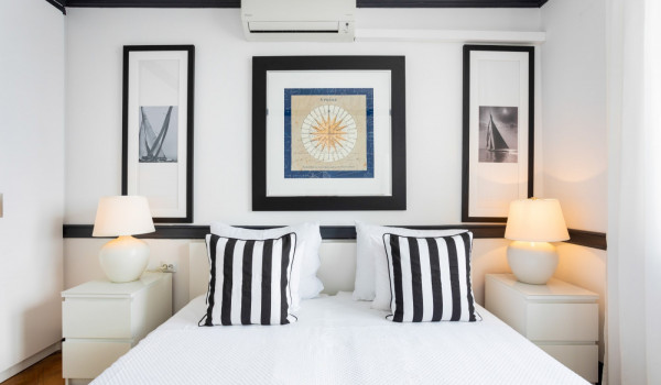 King size bed with striped pillows in the modern beachfront villa Sea Diamant in Dubrovnik