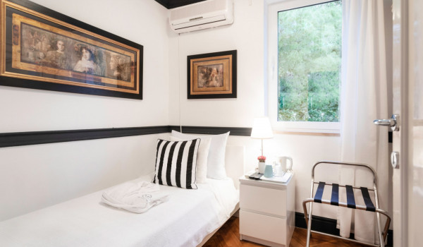 Single bed in the bedroom with view of the garden in the luxury beachfront villa in Dubrovnik with private pool