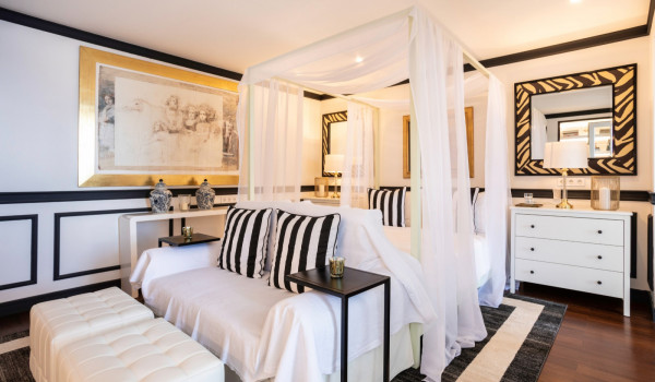 Bedroom with queen size bed and sofa for relaxing in the modern family villa with private beach in Dubrovnik