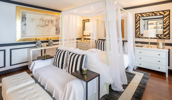 Bedroom with queen size bed and sofa for relaxing in the modern family villa with private beach in Dubrovnik