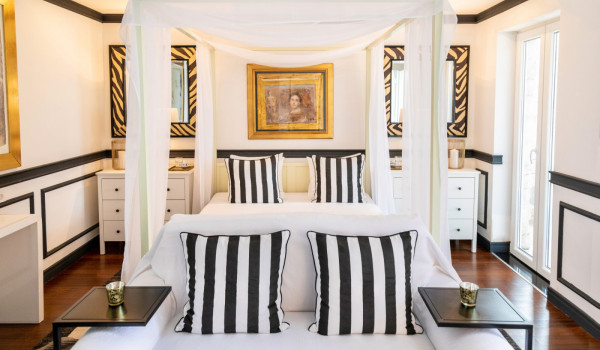 Bedroom with queen size bed and sofa for relaxing in the modern family villa with private beach in Dubrovnik