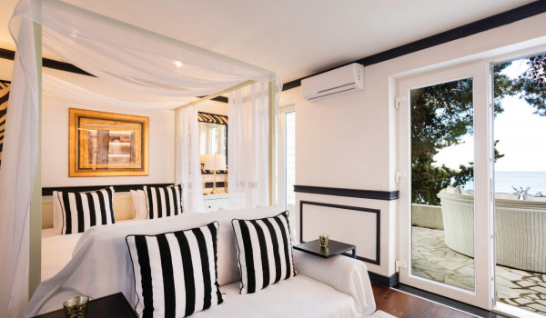 Bedroom with queen size bed and direct entrance to the terrace of the modern vacation villa in Dubrovnik