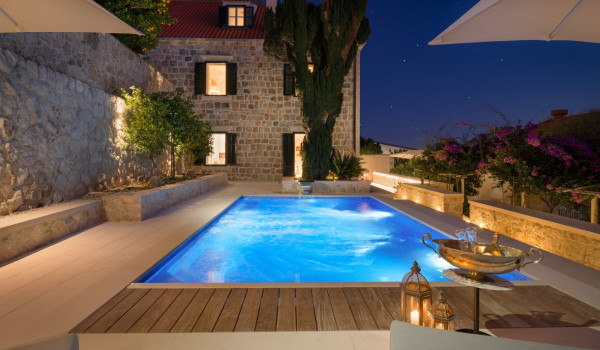 Private terrace of Croatia luxury villa for rent with pool surrounded by deckchairs and sundeck