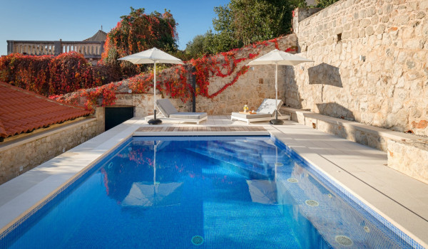 Private terrace of the luxury Dalmatia villa Dubrovnik Stone Beauty with pool surrounded by deckchairs