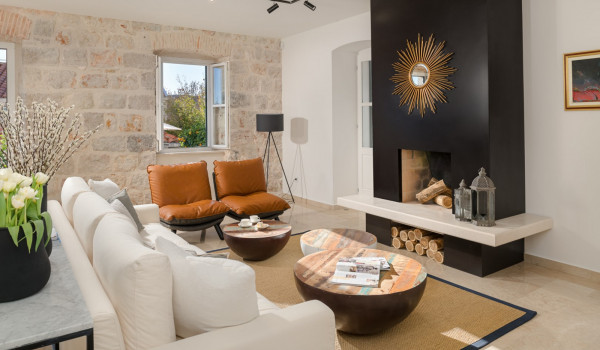 Living room area of the luxury pool villa Dubrovnik Stone Beauty with sofas and fireplace for vacation
