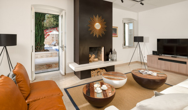 Living room area of Croatia luxury pool villa with indoor fireplace and SMART TV for family vacation