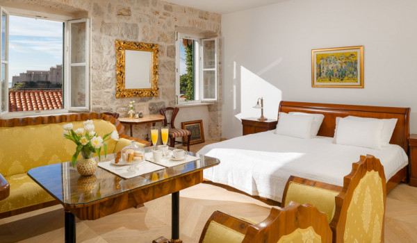 Bedroom of Croatia luxury sea view villa with king-size bed and seating area for vacation and rent