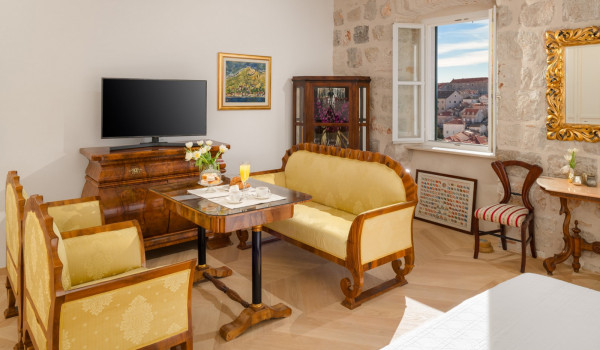 Bedroom of Croatia luxury sea view villa with king-size bed and seating area for vacation and rent