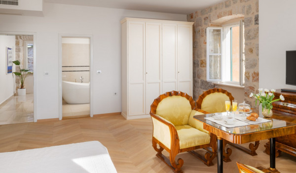 Bedroom of Croatia luxury sea view villa with king-size bed and seating area for vacation and rent