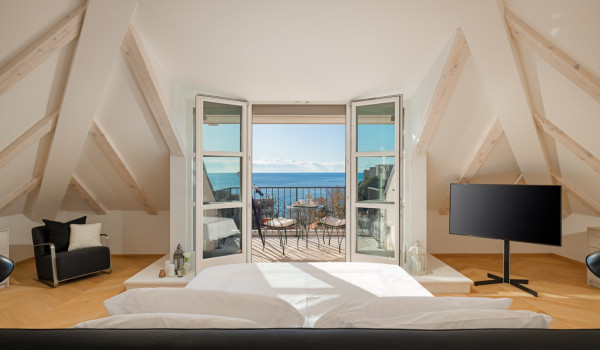 Bedroom of Croatia luxury pool villa with king-size bed and private balcony with sea view for vacation