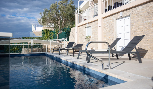 Lounge chairs by the private pool of the Luxury Villa Sea Hug
