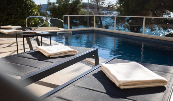 Lounge chairs by the private pool of the Luxury Villa Sea Hug