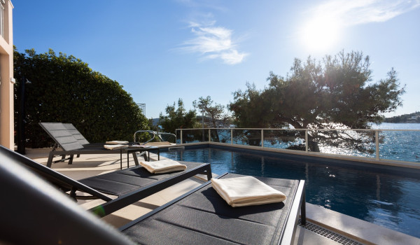 Lounge chairs by the private pool of the Luxury Villa Sea Hug