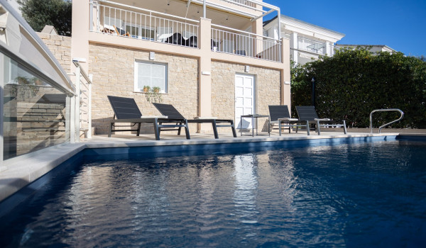 Lounge chairs by the private pool of the Luxury Villa Sea Hug