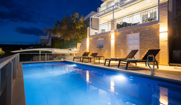 Lounge chairs by the private pool of the Luxury Villa Sea Hug