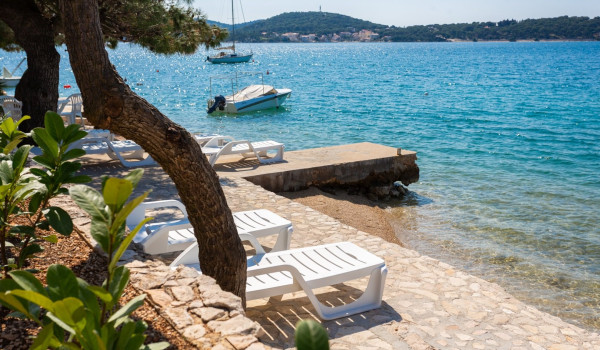 Lounge chairs on the beach of the Luxury Villa Sea Hug