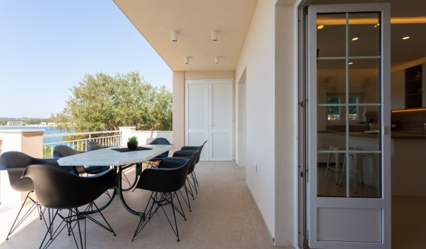 Dining area on the terrace of a Luxury Villa Sea Hug by the sea