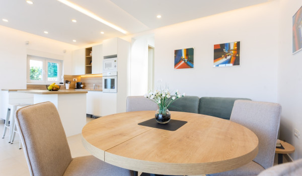 Dining area and living room in a family villa Sea Hug with private pool