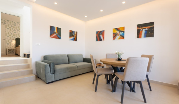 Dining area and living room in a family villa Sea Hug with private pool