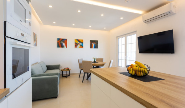 Dining area and living room in a family villa Sea Hug with private pool