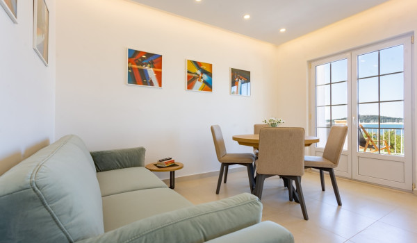 Dining area and living room in a family villa Sea Hug with private pool