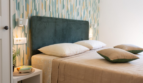 Double bed in a bedroom of a family villa Sea Hug