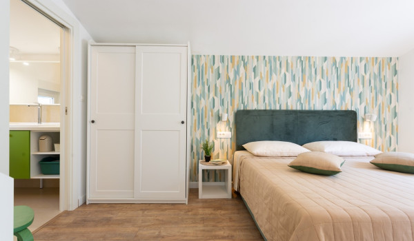 Double bed in a bedroom of a family villa Sea Hug