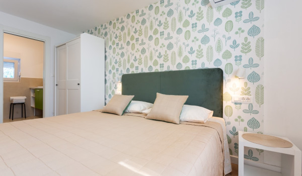 Double bed in a bedroom of a family villa Sea Hug