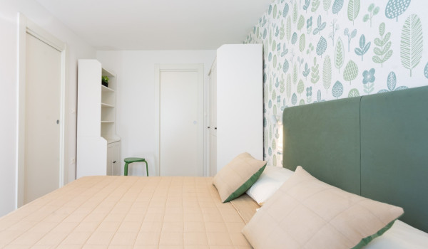 Double bed in a bedroom of a family villa Sea Hug