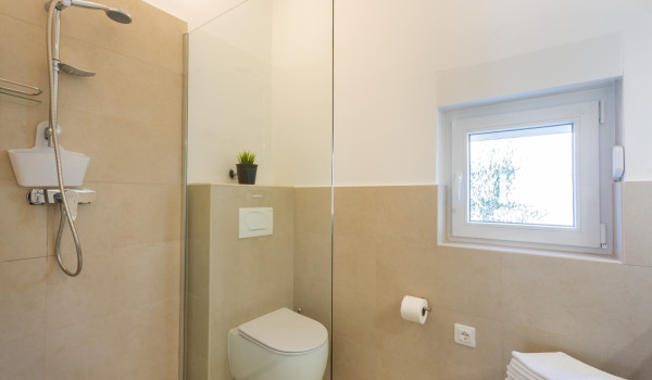 En suite bathroom in a Luxury family villa Sea Hug with a private pool