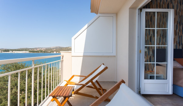 Lounge chairs on the balcony of a Luxury family villa Sea Hug
