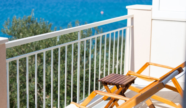 Lounge chairs on the balcony of a Luxury family villa Sea Hug