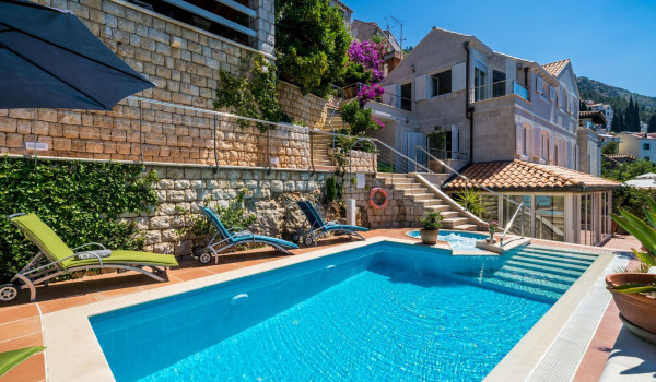 Sun loungers by the pool overlooking the sea of Croatia luxury villa for vacation with friends