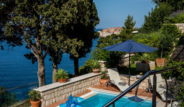 Sun loungers by the pool overlooking the sea of the Dubrovnik luxury villa for vacation with friends
