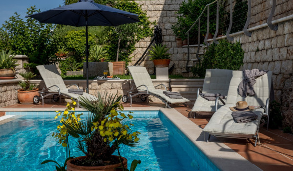 Sun loungers by the pool overlooking the sea of the Dubrovnik luxury villa for vacation with friends