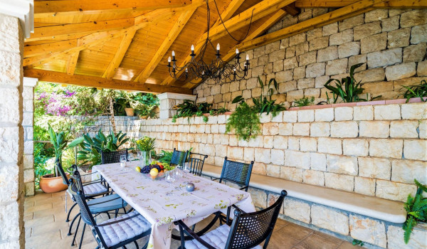 Outside dining table on the terrace of the luxury vacation villa with concierge service