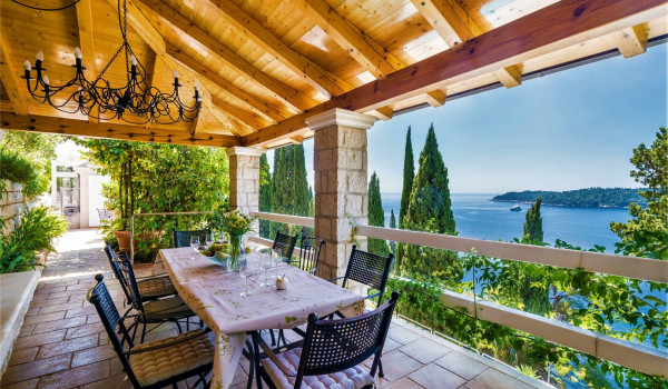 Outside dining table on the terrace of the luxury vacation villa with sea view