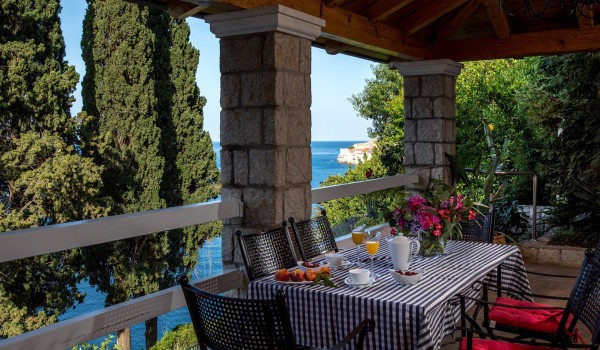 Outside dining table on the terrace of the luxury vacation villa Dubrovnik Palace with concierge service