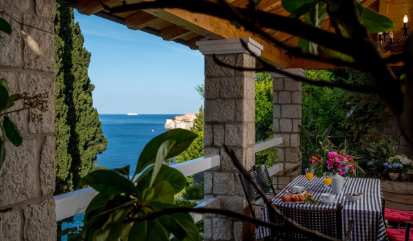 Outside dining table on the terrace of the luxury vacation villa Dubrovnik Palace with concierge service