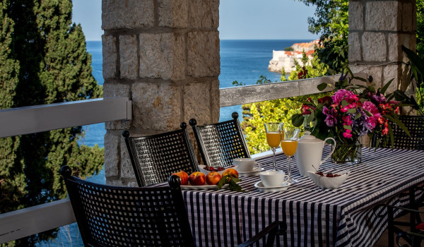 Outside dining table on the terrace of Croatia luxury vacation villa Dubrovnik Palace with concierge service