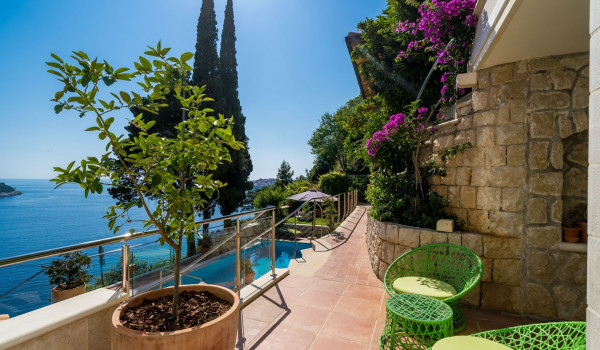 Seating area by the pool of the luxury holiday villa with wine cellar and concierge service