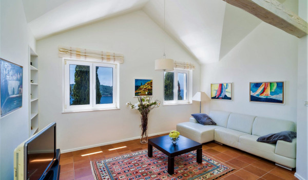 Living room with comfortable sofa and TV in the luxury villa for family vacation by the sea in Dubrovnik