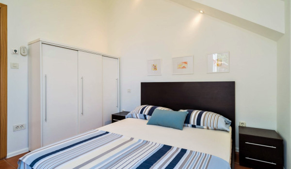 Queen size bed in a bedroom of the Luxury family villa with private pool and jacuzzi in Dubrovnik