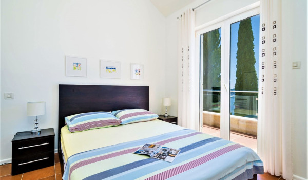 Queen size bed in a bedroom of the Luxury family villa with private pool and jacuzzi in Dubrovnik