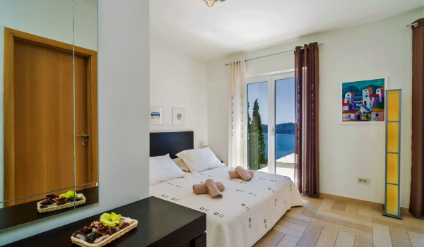 Queen size bed in a bedroom of the Luxury family villa with private pool and jacuzzi in Dubrovnik