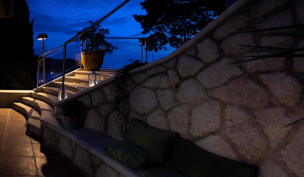 Outdoor seating area and stairs of the luxury vacation villa by the sea with concierge service