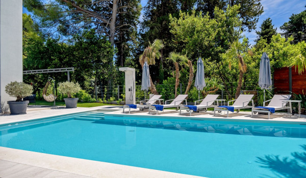 Sunloungers and outdoor shower next to the private pool on the patio of the luxury villa Velvet Bourbon Split